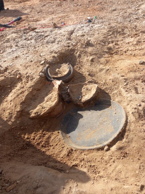 Collection of vessels (including the platter) still being excavated