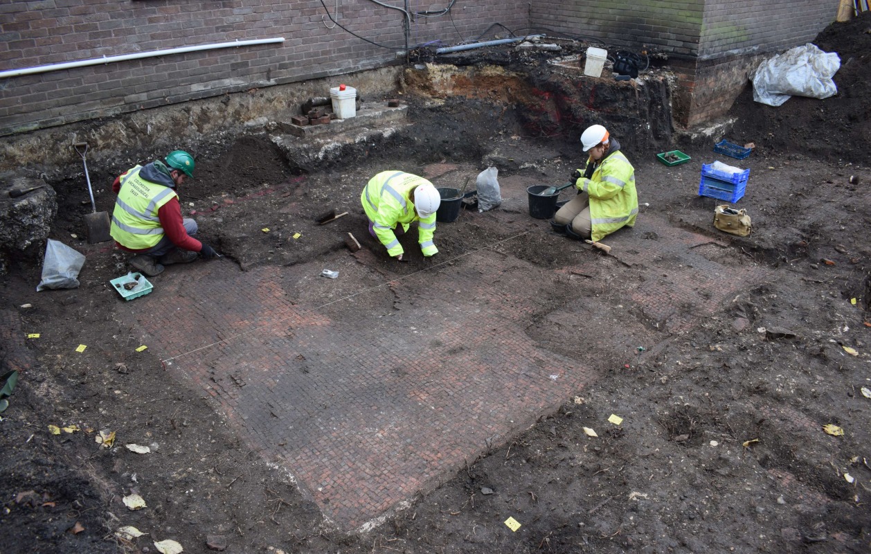 Members of CAT staff working to uncover one of the tessellated floors
